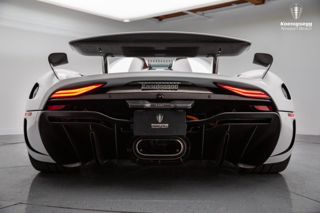 Parte trasera del Koenigsegg Regera con alerón elevado, difusor en fibra de carbono y luces LED encendidas